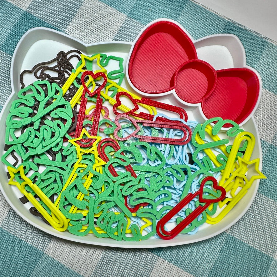 Colourful handmade paper clips in a cat-shaped tray